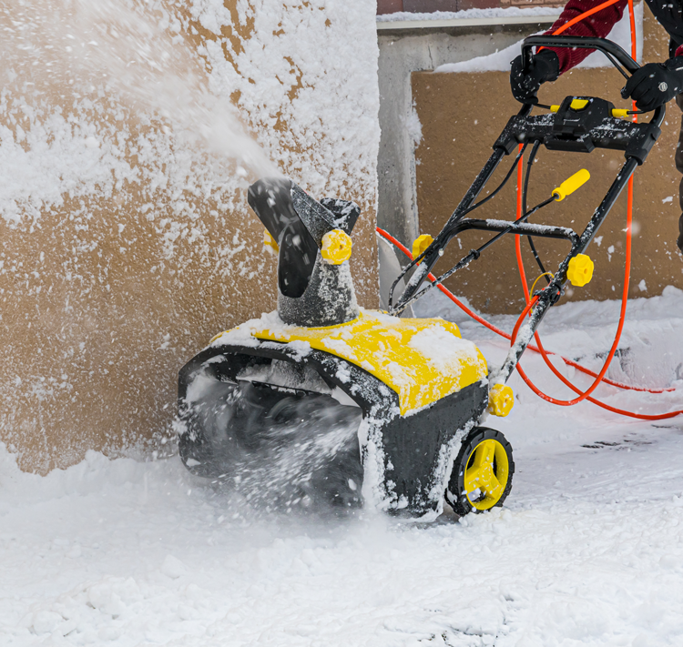 Electric snow blower in operation
