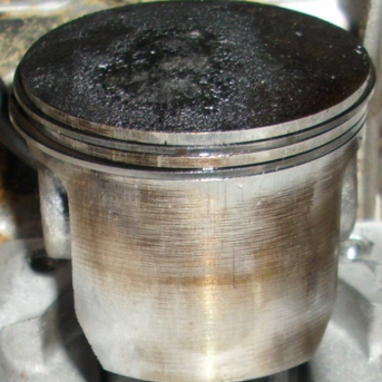 Encrusted piston